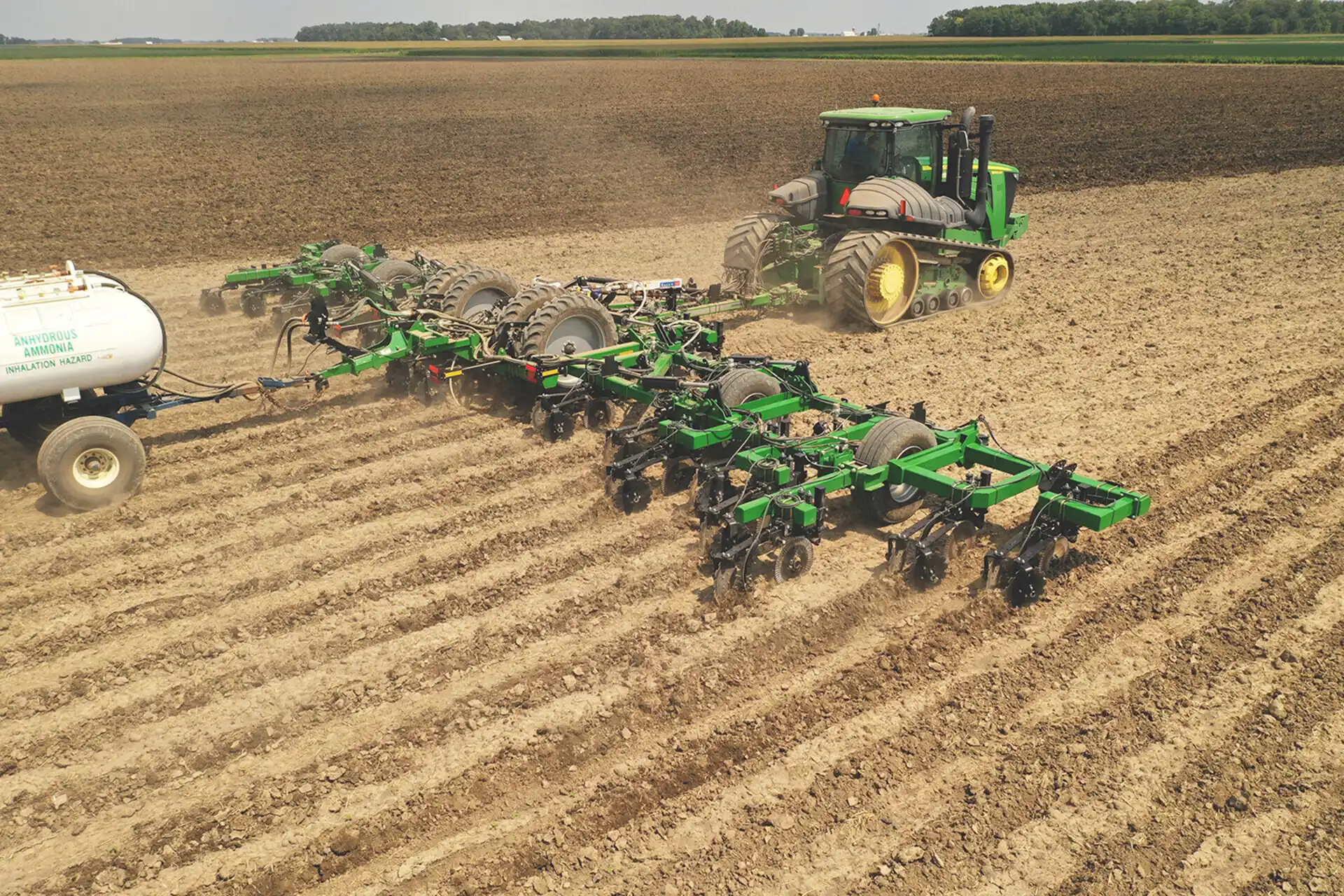 Tractor applying anhydrous ammonia fertilizer in agricultural field
